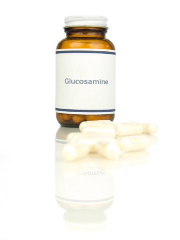 Glucosamine capsules and bottle.